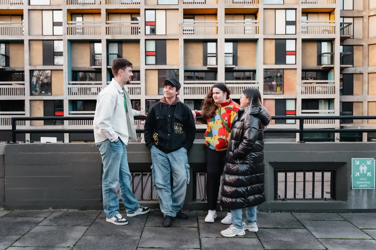 Four students stood talking outside Beton House